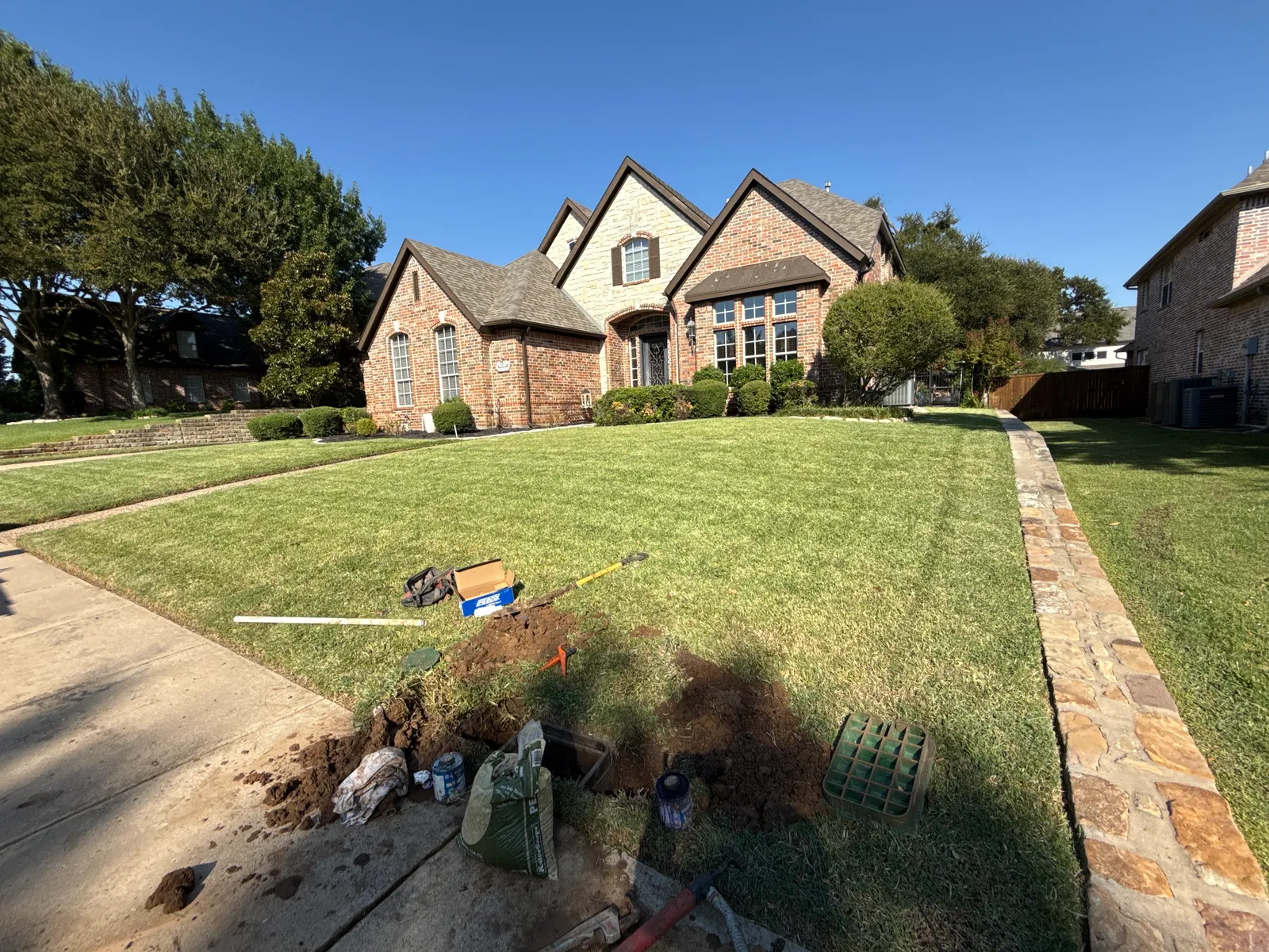 A JC Apex Home Services sprinkler repair in progress at a Plano TX home